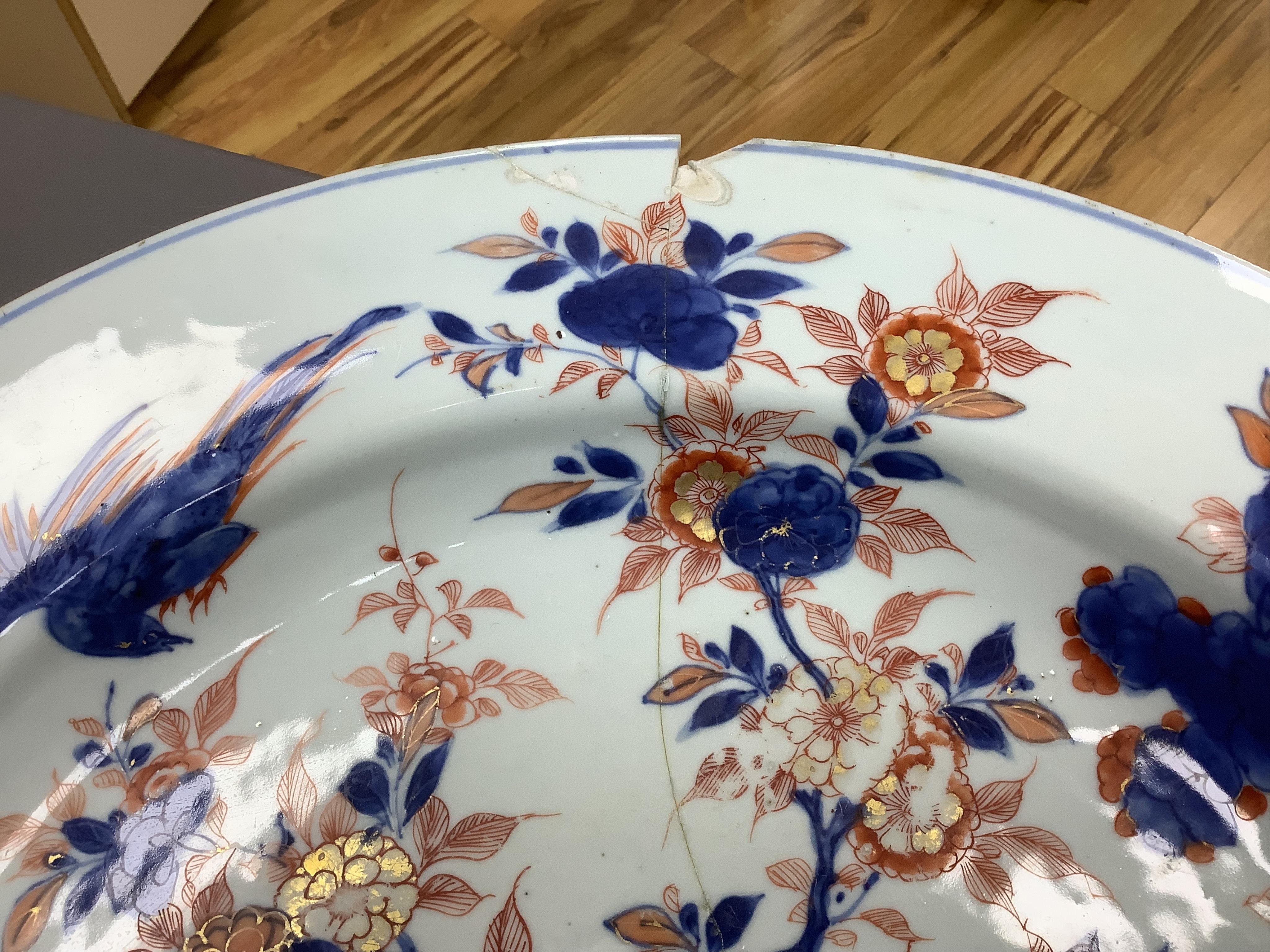 Three early 18th century Chinese Imari dishes (one clobbered), largest 46.5cm, together with a 19th century Chinese powder blue ground vase, 44cm high and a horn carving, 13.7cm (5)